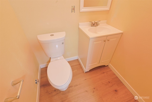 bathroom featuring hardwood / wood-style flooring, vanity, and toilet