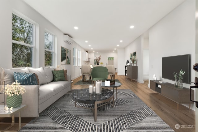 living room with a wall unit AC and wood-type flooring