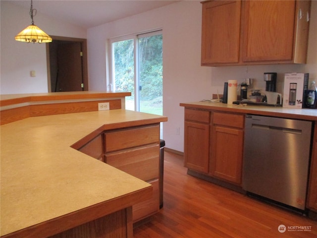 kitchen featuring dishwasher, hardwood / wood-style flooring, and decorative light fixtures