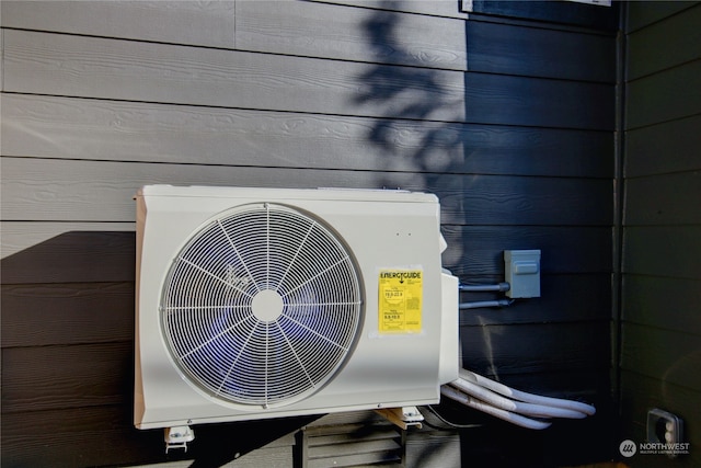 exterior details featuring wooden walls and ac unit