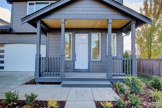 doorway to property with a garage and covered porch