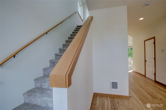 stairs with wood-type flooring