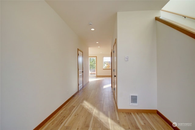 corridor with light wood-type flooring