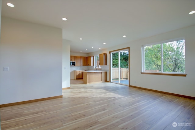 unfurnished living room featuring light hardwood / wood-style flooring