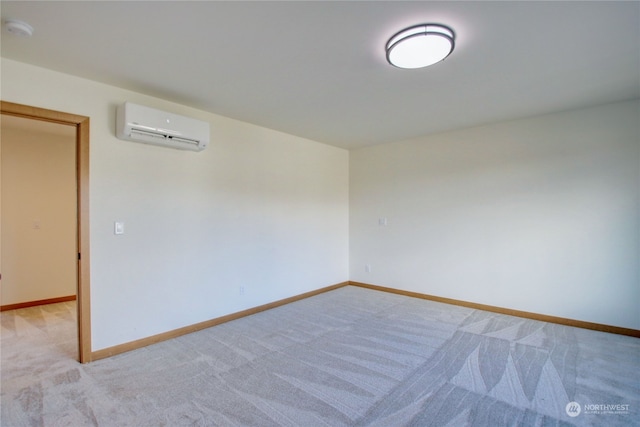 spare room with light carpet and a wall mounted air conditioner