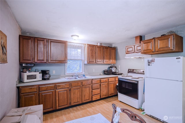 kitchen featuring light hardwood / wood-style floors, white appliances, sink, and exhaust hood