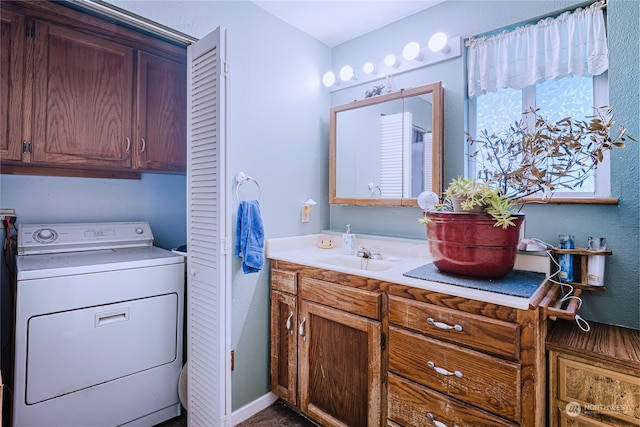 bathroom featuring vanity and washer / clothes dryer