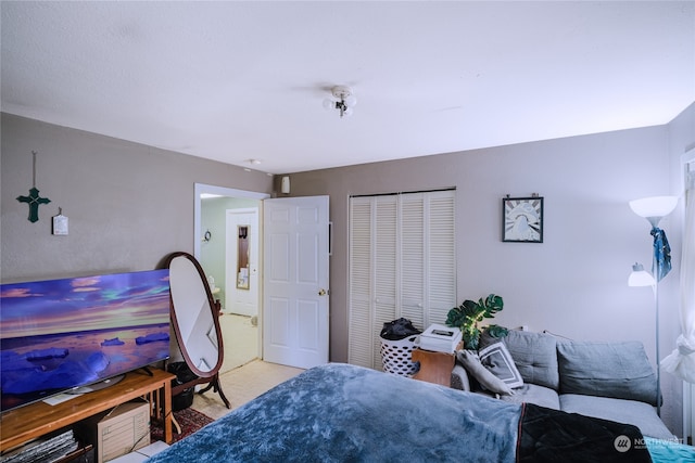 carpeted bedroom with a closet