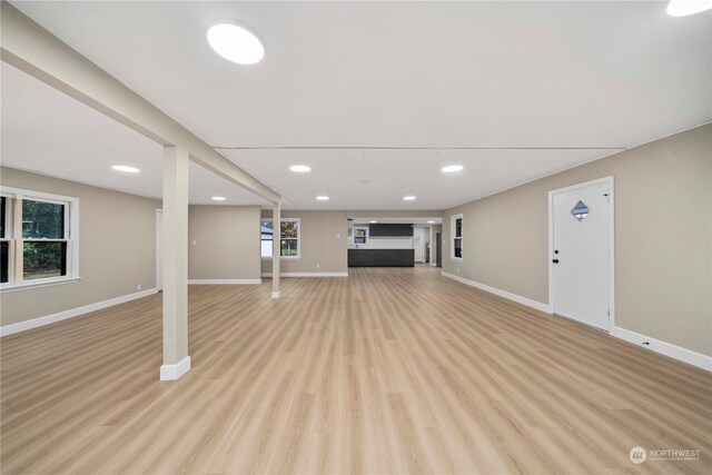 basement with light hardwood / wood-style floors