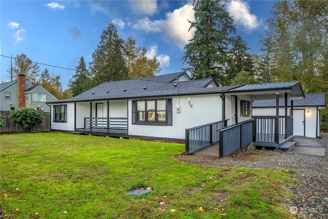 rear view of property featuring a yard