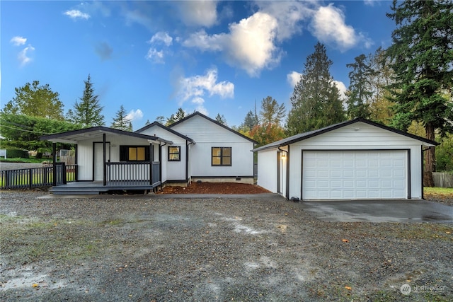 view of front of house featuring a garage and an outbuilding