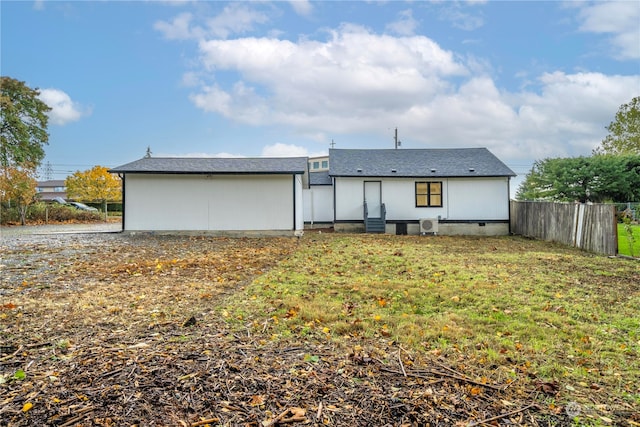 rear view of house with a lawn