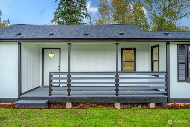 back of property featuring a porch and a lawn