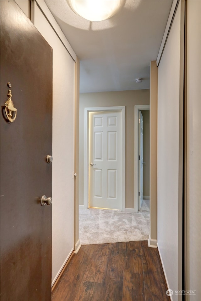 corridor with dark wood-type flooring