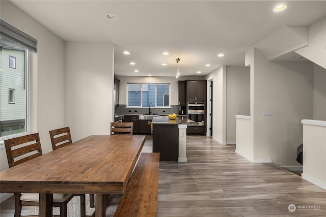 dining room featuring sink and hardwood / wood-style flooring