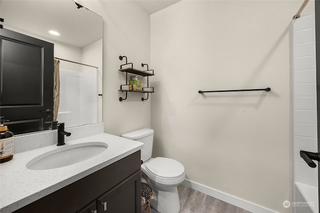 bathroom featuring vanity, toilet, wood-type flooring, and walk in shower