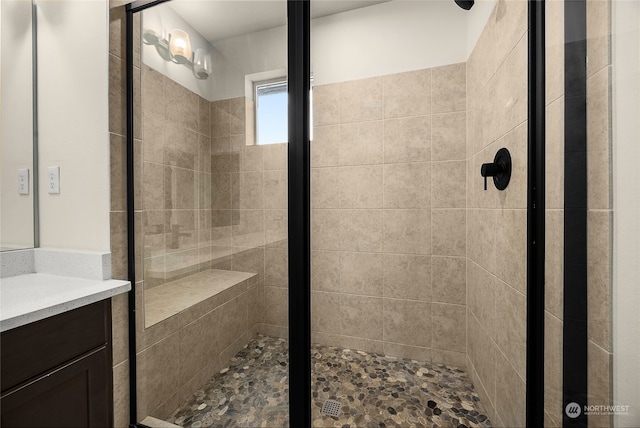 bathroom featuring vanity and a tile shower