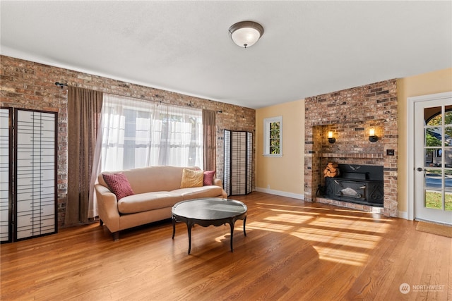 living room featuring brick wall and light wood-type flooring