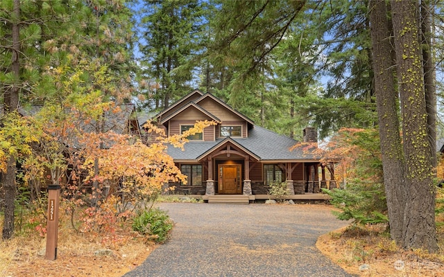 1251 Pinegrass Loop, Cle Elum, WA 98922 - chalet / cabin with a porch, aphalt driveway, a chimney, and stone siding