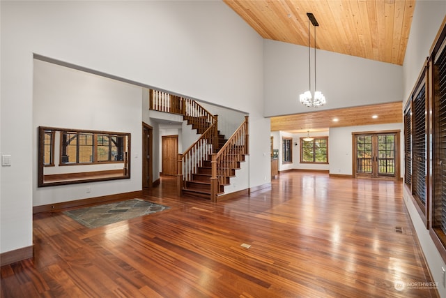 unfurnished living room with a notable chandelier, wood-type flooring, high vaulted ceiling, and wood ceiling