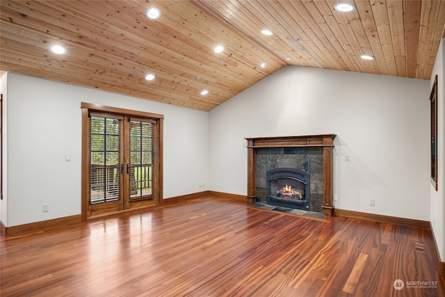 unfurnished living room featuring lofted ceiling, wood ceiling, wood-type flooring, and a tile fireplace