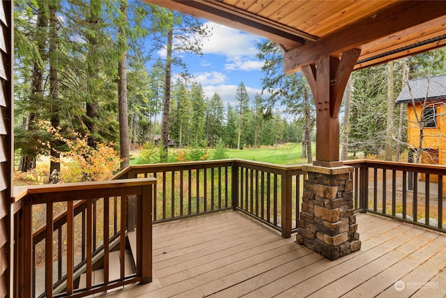 wooden terrace with a lawn