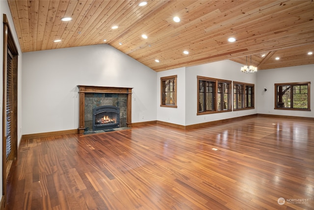 unfurnished living room with a tiled fireplace, wooden ceiling, lofted ceiling, and hardwood / wood-style floors