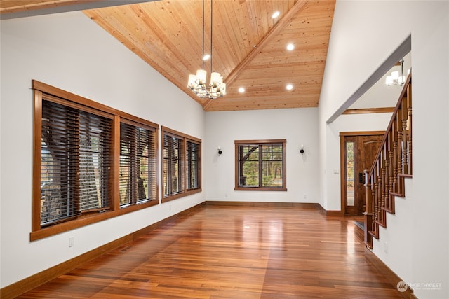 unfurnished room with a notable chandelier, hardwood / wood-style flooring, high vaulted ceiling, and wooden ceiling