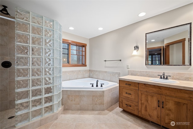 bathroom featuring vanity, plus walk in shower, and tile patterned flooring