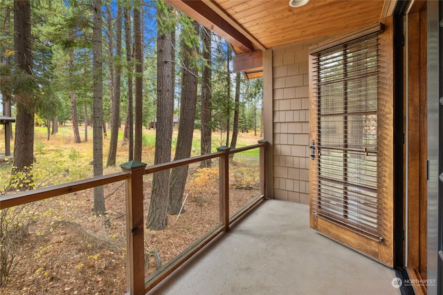 unfurnished sunroom with wood ceiling