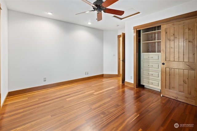 unfurnished bedroom featuring hardwood / wood-style flooring, a closet, and ceiling fan