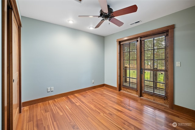 spare room featuring ceiling fan and light hardwood / wood-style flooring