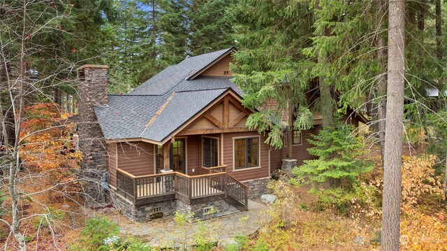 1251 Pinegrass Loop, Cle Elum, WA 98922 - view of front of house with a chimney, a porch, and roof with shingles