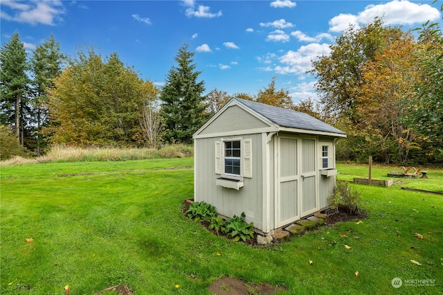 view of outdoor structure with a lawn