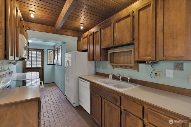 kitchen with brown cabinets, a sink, white appliances, brick patterned floor, and wooden ceiling