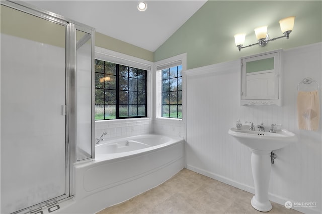 bathroom featuring sink, vaulted ceiling, and plus walk in shower