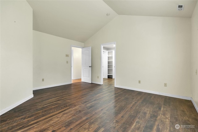 interior space featuring baseboards, high vaulted ceiling, and wood finished floors