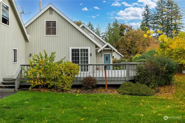 back of house featuring a deck and a yard