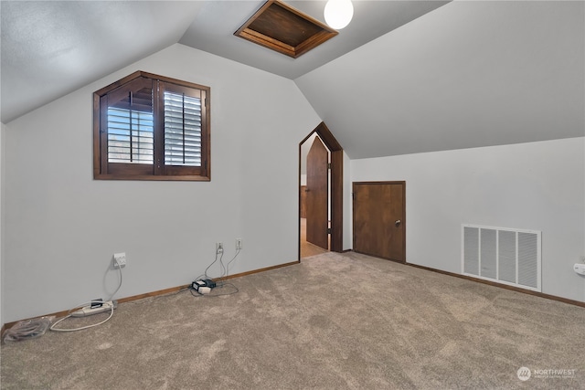 additional living space with vaulted ceiling and light colored carpet