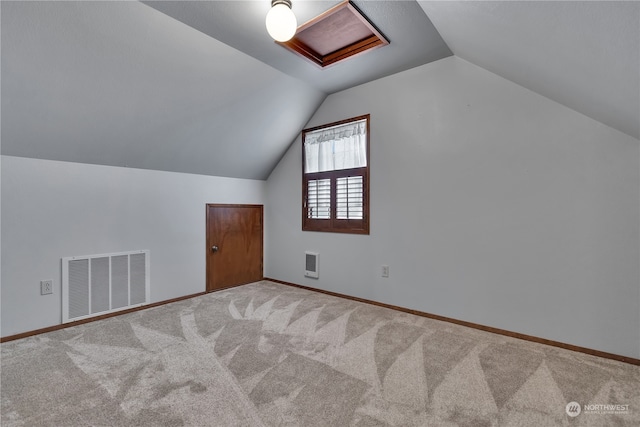 additional living space with lofted ceiling, carpet flooring, and heating unit