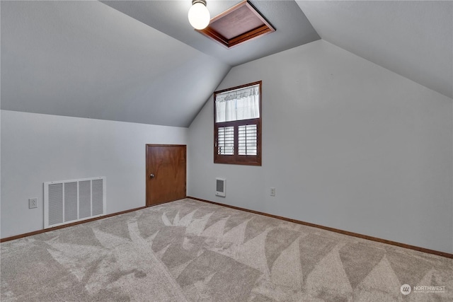 bonus room featuring attic access, visible vents, baseboards, lofted ceiling, and carpet flooring