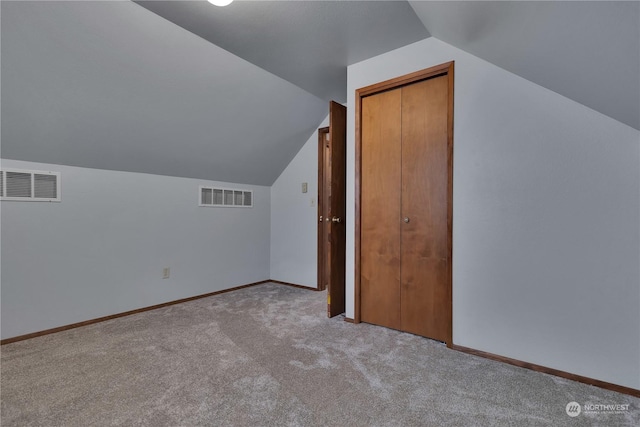 bonus room with visible vents, carpet flooring, and vaulted ceiling