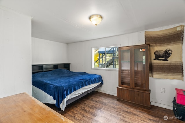 bedroom with dark hardwood / wood-style floors