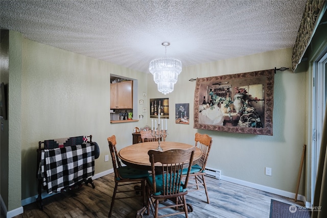 dining area featuring dark hardwood / wood-style flooring, a baseboard radiator, a textured ceiling, and a notable chandelier