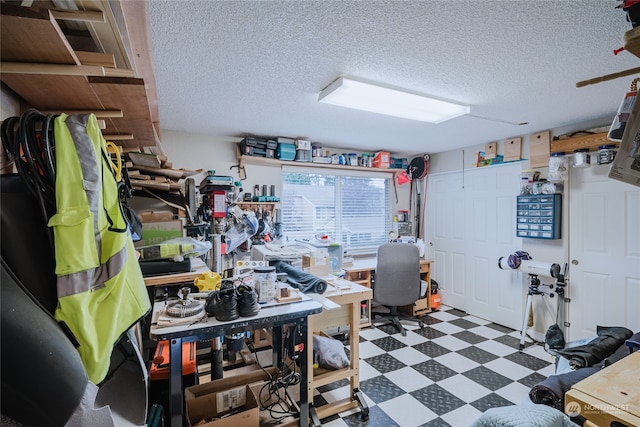 interior space with a textured ceiling and a workshop area