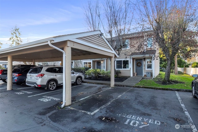 view of parking / parking lot featuring a carport