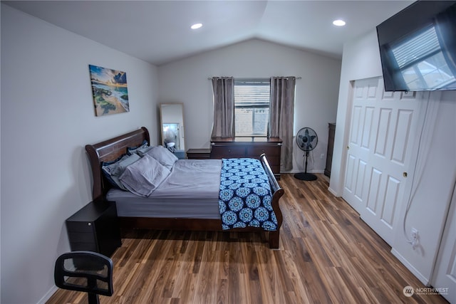 bedroom featuring lofted ceiling and dark hardwood / wood-style flooring