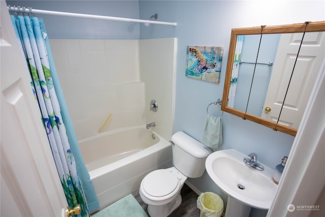 full bathroom with shower / bath combo with shower curtain, toilet, and sink