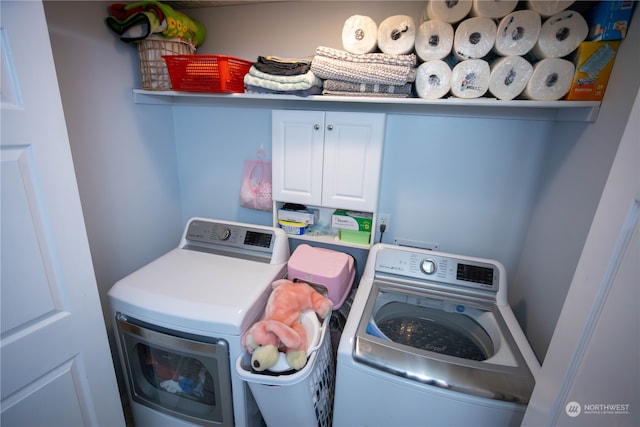 laundry area featuring cabinets and separate washer and dryer