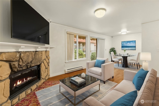 living room with hardwood / wood-style floors, baseboard heating, and a fireplace